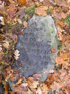 The rough boulder-style matzevah of an elderly woman, "Bashe(?) daughter of Eliezer (d. c. 1900). Bagnowka Cemetery, section 49.